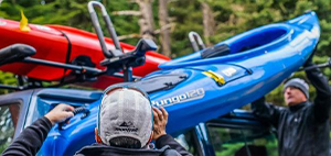 Kayak being loaded onto roof racks